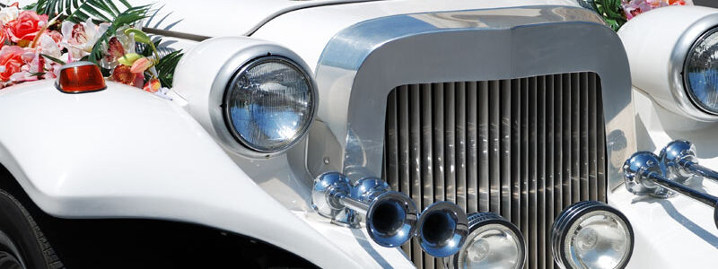 White wedding limousine with flowers